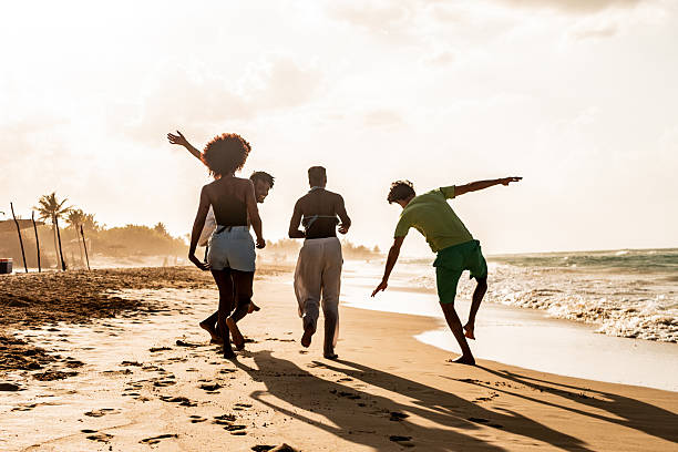 istock Happy young friends celebrating on the beach 2209036114