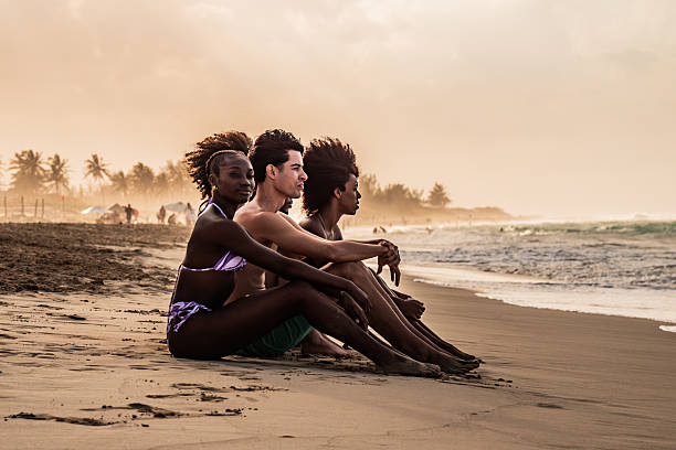 Young friends looking at view on the beach