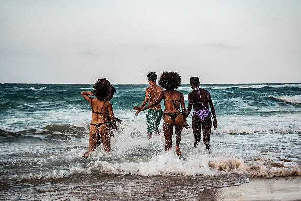 Young friends playing on the beach