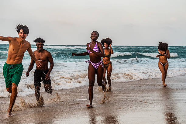 istock Young friends playing on the beach 2209036176