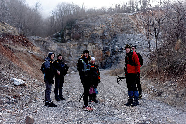 istock Group of hikers resting on a rocky trail during a winter excursion 2209037850
