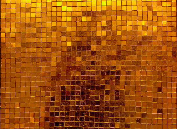 Abstract textured background of gold leaf square shapes on a grungy old rusty weathered metal background.