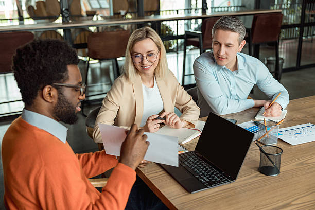 istock Group of business consultants looking involved while discussing a new case 2209039104