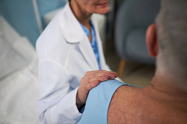 istock Medical Professional Examining Patient's Shoulder in Clinic Setting 2209039715