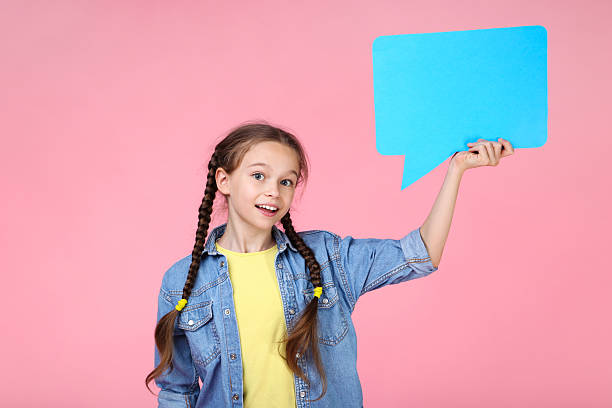 istock Young girl with speech bubble on pink background 2209039957