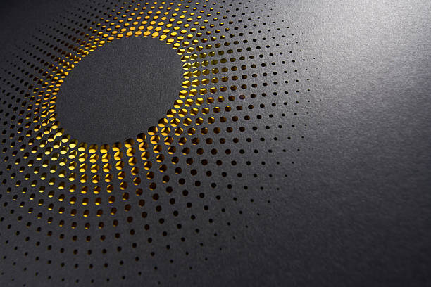 istock Modern abstract circular paper cut design with radial dot pattern and glowing yellow backlight on black surface 2209040002