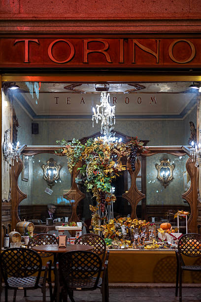 Turin, Italy - Nov 09 2021: Window display of the legendary TORINO tea room with autumn decorations on Piazza San Carlo.
