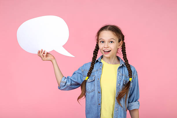 istock Young girl with speech bubble on pink background 2209042461