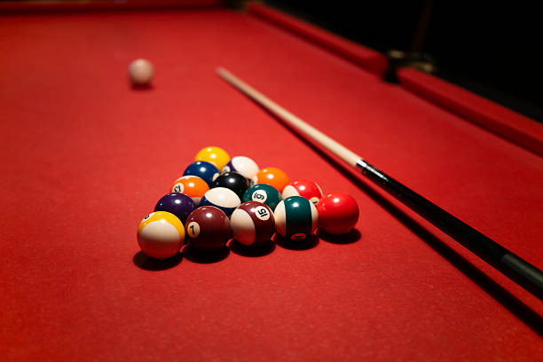 istock Racked biliard balls and cue on biliard table 2209044478