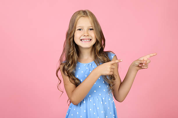 istock Pretty little girl on pink background 2209044895