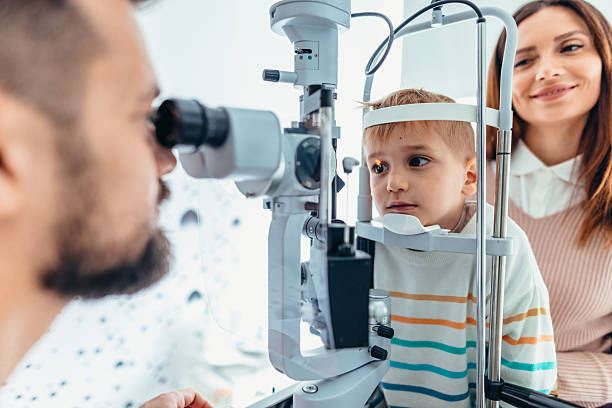 istock Child Undergoing an Eye Examination at the Ophthalmologist With Parent Observing 2209045140