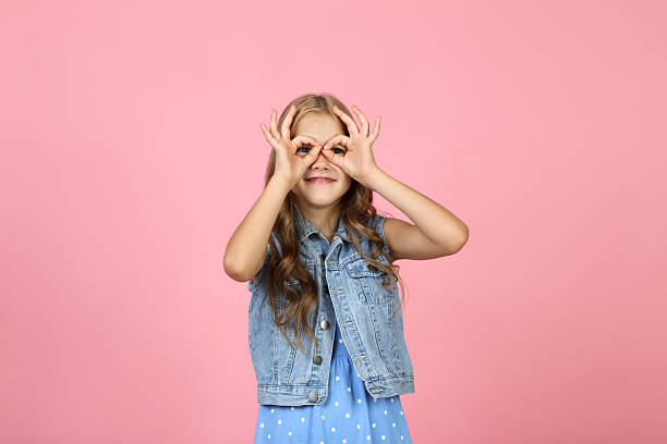 istock Pretty little girl on pink background 2209045200