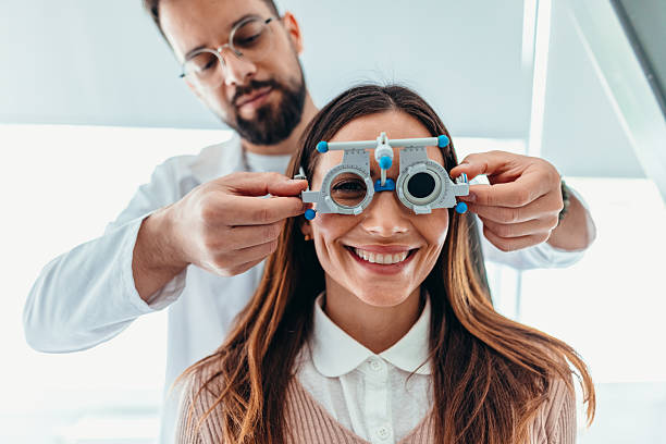 istock Optometrist Examining Smiling Patient With Testing Equipment During Eye Appointment 2209045217