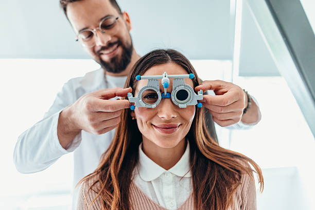 Optometrist Adjusting Testing Glasses on Patient During an Eye Exam