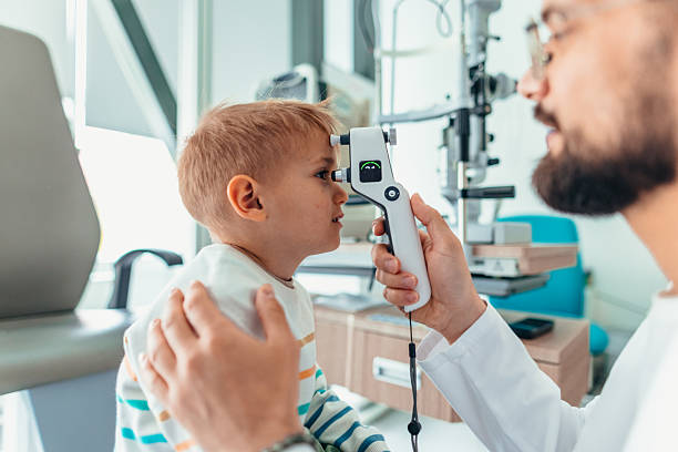 istock Optometrist Examines Young Child's Vision During An Eye Checkup 2209045270