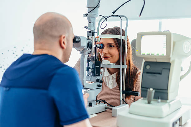 istock Optometrist Performing Eye Examination With Patient Using Diagnostic Equipment 2209045487
