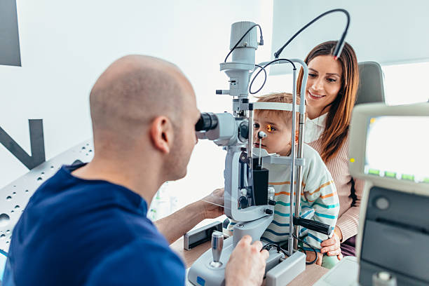 istock Child Undergoing Eye Examination with Parent at Optometrist Clinic 2209045884