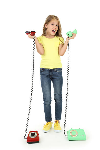 Beautiful little girl with handsets on white background