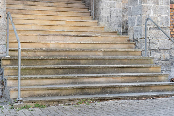 istock Wide stone staircase with metal handrails 2209046777