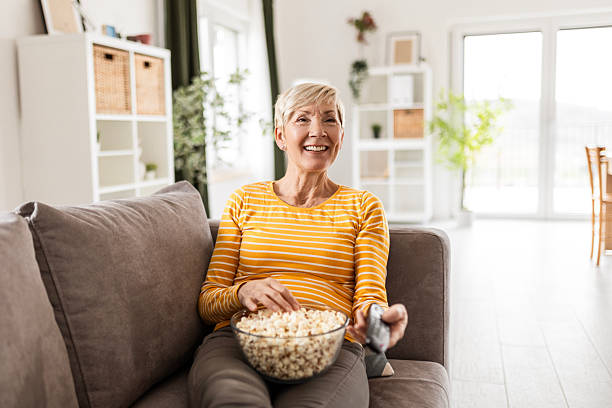 istock Senior Relaxation – Popcorn, TV, and a Cozy Sofa 2209046790