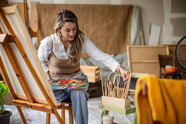 istock Engaging in creative activities, an artist working on a colorful canvas in a bright and inspiring indoor studio space 2209046825