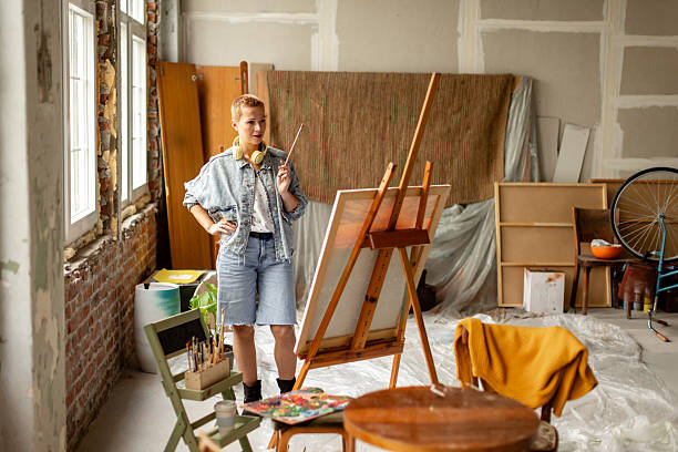 istock Creative adult artist in a spacious studio contemplating artwork during a leisure evening indoors 2209047339