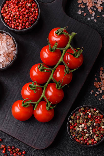 istock Red cherry tomatoes on a branch, a vegetable as an ingredient for making sauces 2209049264