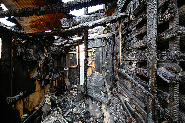 istock Consequences of fire. Burnt wooden house 2209049278