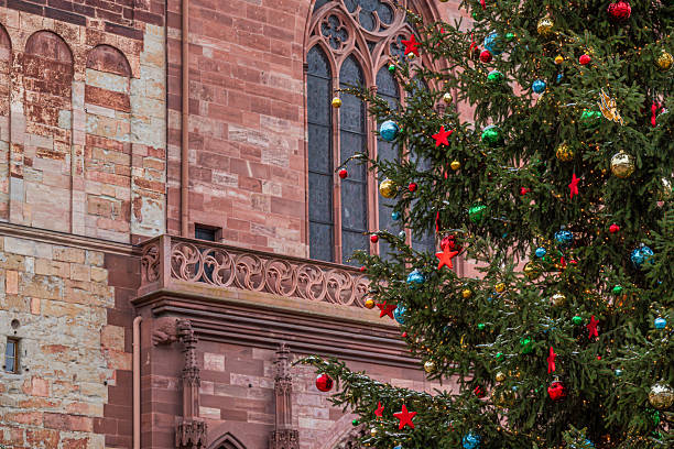 istock Christmas tree with colorful ornaments in front of Basel Minster 2209051423