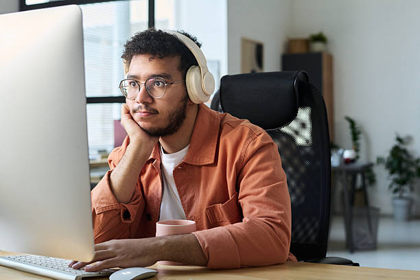 istock Man watching online video by workplace 2209054360
