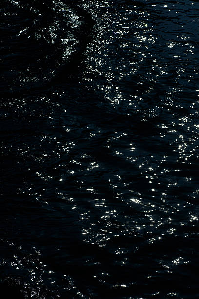 istock Light flickering in the abyss - an abstract painting drawn by the water surface. 2209054844