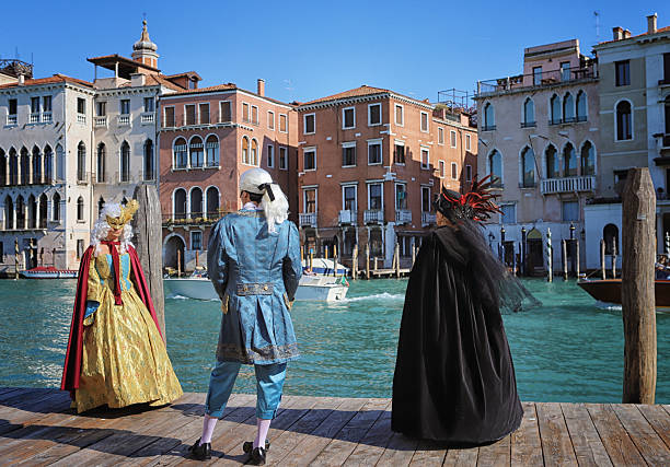 Venice, Italy - June 23, 2025: Tourists are experiencing a gondola ride in Venice, surrounded by stunning reflections and historic buildings