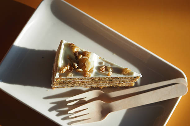 A very tempting and delicious slice of walnut cake beautifully presented on a white plate