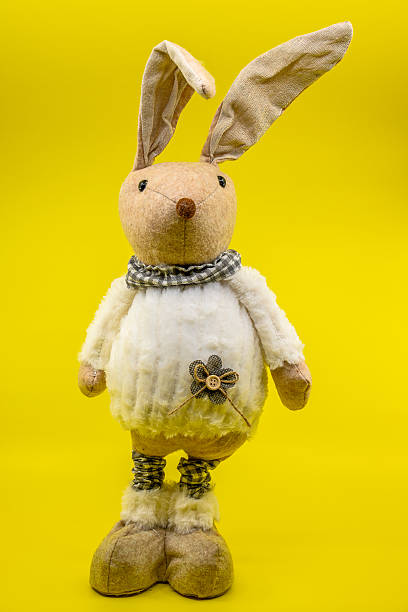 istock Easter bunny plush toy on yellow background 2209066357