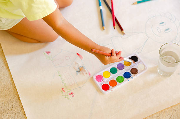 istock Kid painting with watercolors. 2209069312