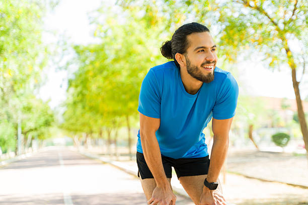 istock Runner resting after workout on running track in park 2209069418