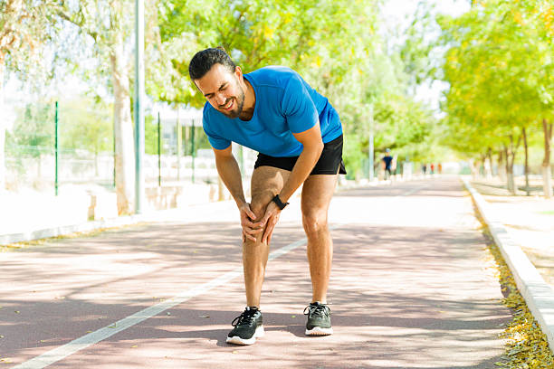 istock Runner suffering knee pain during outdoor workout on running track 2209069569