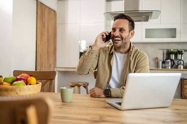 istock Happy entrepreneur working from home having a phone call 2209069626