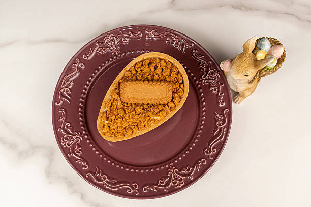 Caramel chocolate Easter egg with puff pastry and French vanilla cream filling_top view.
