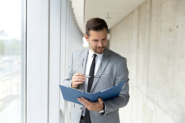 istock Mid adult businessman dealing with paperwork 2209071635