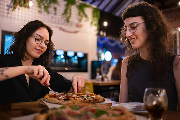 istock Lesbian couple eating pizza 2209072603