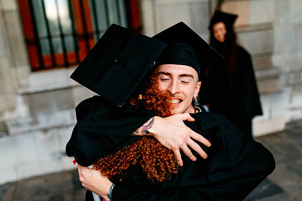 istock Two happy students hugging each other on graduation day 2209072605