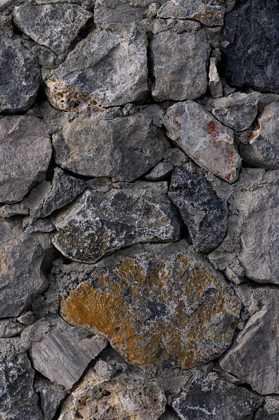istock Textured stone wall adds rustic charm to an ancient building in a serene countryside setting during the golden hour of evening 2209074361