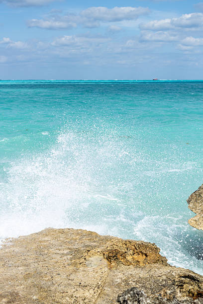 istock Turquoise Ocean View with Splashing Waves and Coastal Rocks 2209074547