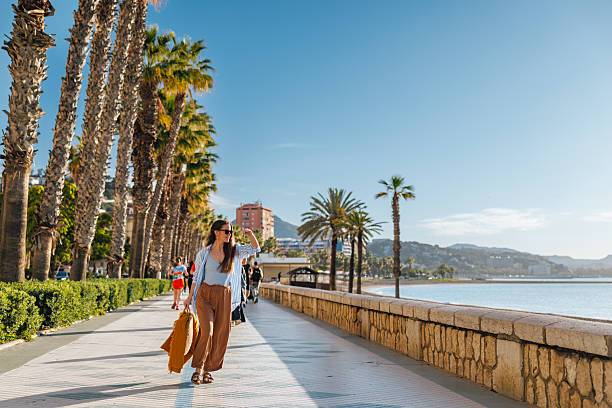 istock Caucasian Friends Strolling Along Malaga Beach Promenade 2209074733