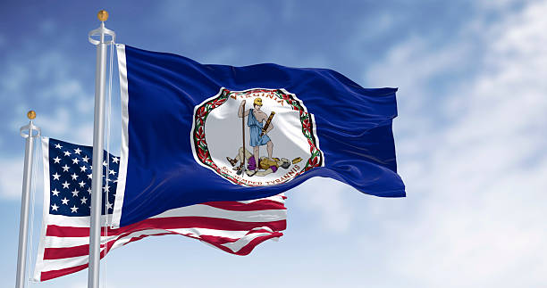istock Virginia and the US flags waving in the wind on a clear day 2209074933