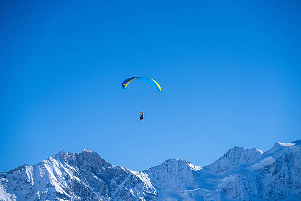 istock Paraglider soars over Swiss Alps 2209076278
