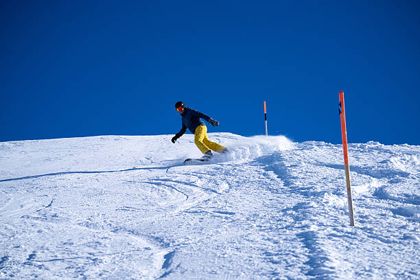 istock Snowboarder descends mountain, Swiss Alps 2209076664