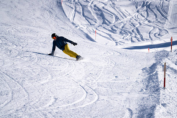 istock Snowboarder descends mountain, Swiss Alps 2209076716