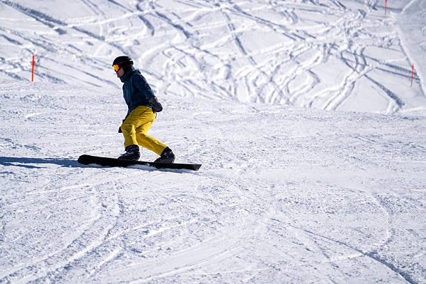 istock Snowboarder descends mountain, Swiss Alps 2209076750